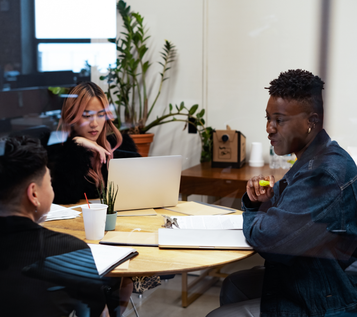 A group of co-workers of varying genders having a meeting