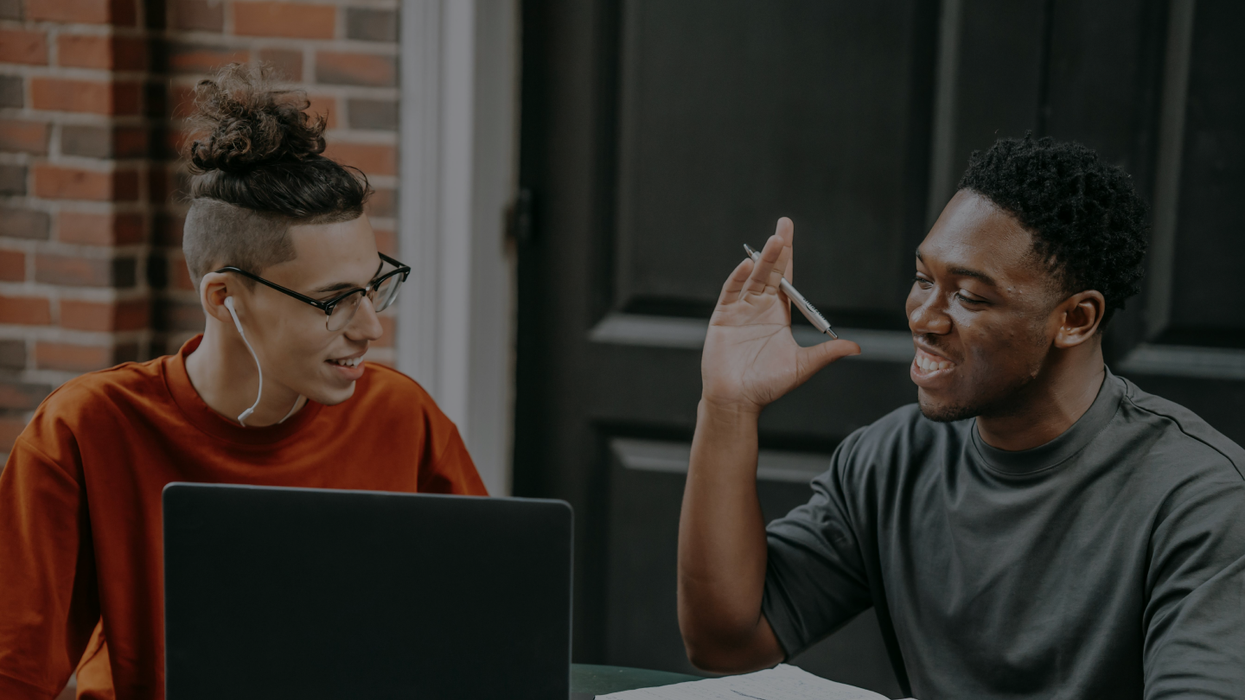 Two people working on a computer