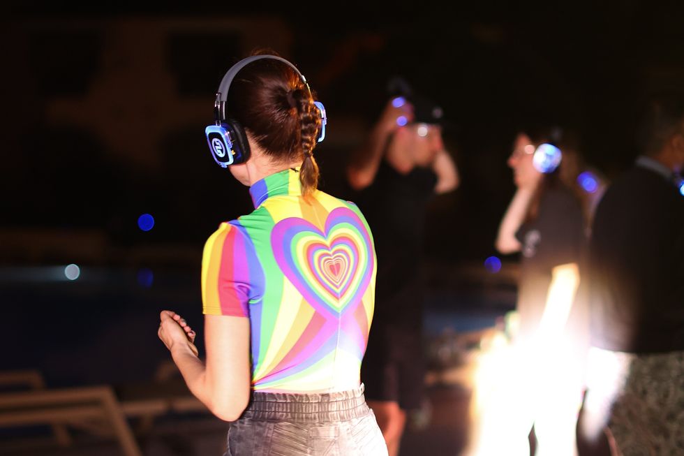 A woman's back during a silent disco party with Camunda