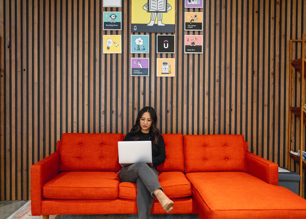 A woman working on a computer in the Udemy office