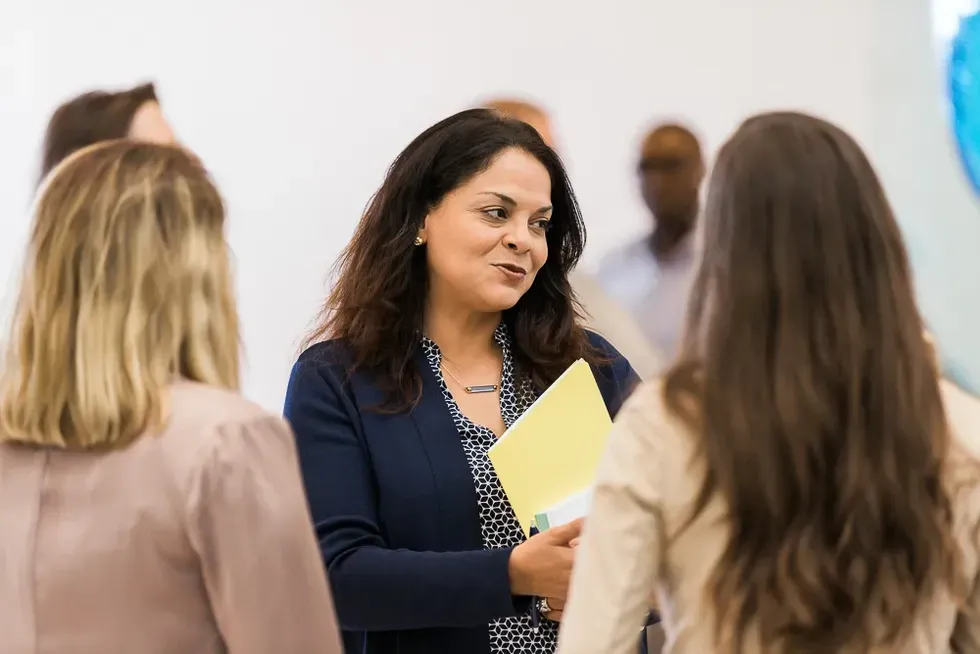 Fireside chat participant Licenia Rojas greets attendees.