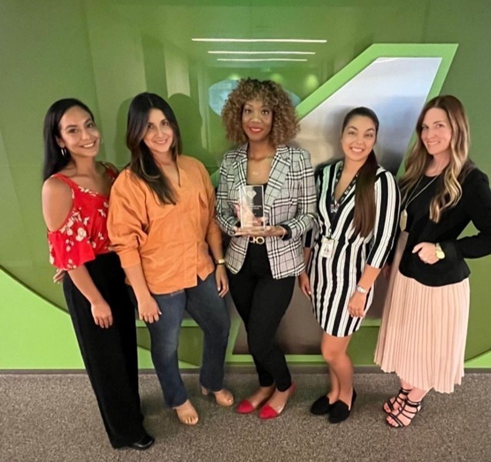 Five women from NASCAR posing for a photo