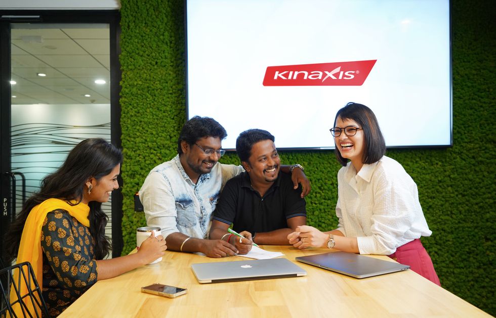 Four Kinaxis employees smiling