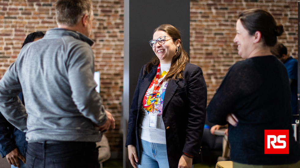 Four RS Americas employees chatting in an office