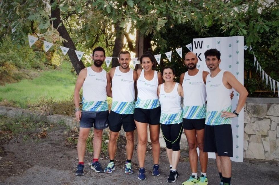 Group of Wolters Kluwer employees posing for a photo after running a race