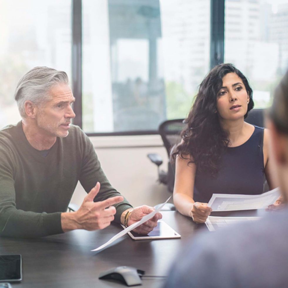 Image of two people talking in a meeting