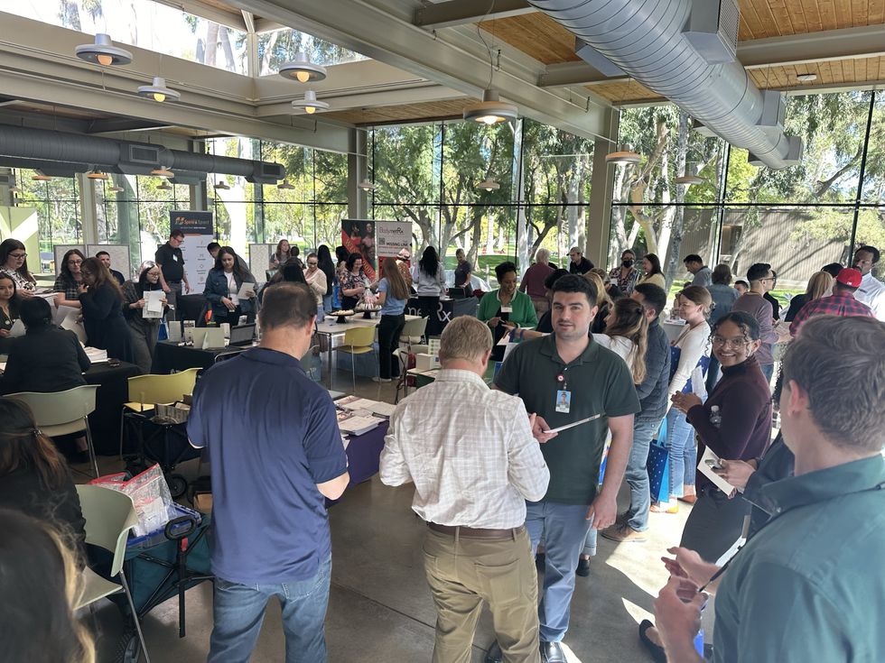 Inside an Esri workplace event with various employees chatting and connecting