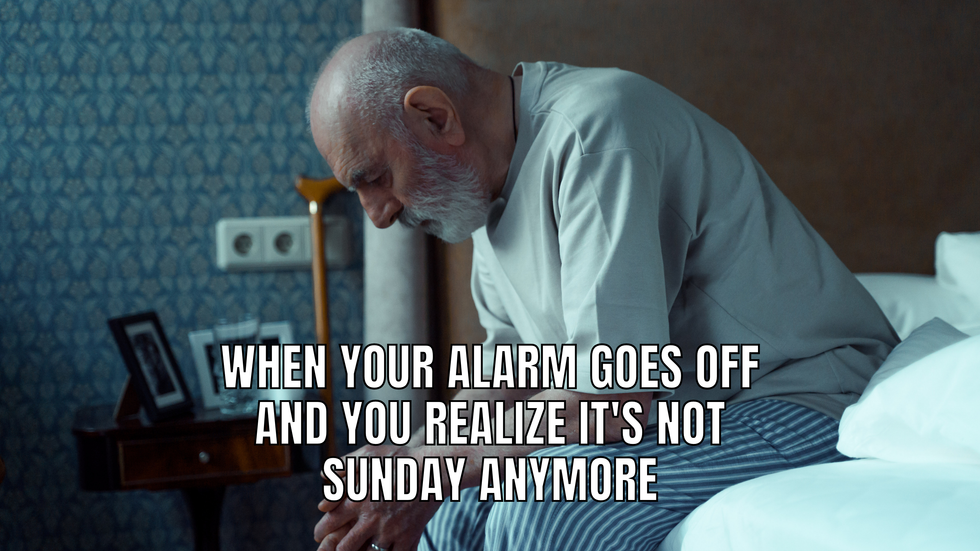 Man leaning over his bed in the morning, looking sad. The text says: When your alarm goes off and you realize it's not Sunday anymore.