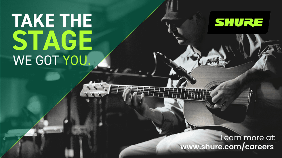 Man playing acoustic guitar in a recording studio, representing creativity and career growth opportunities at Shure.