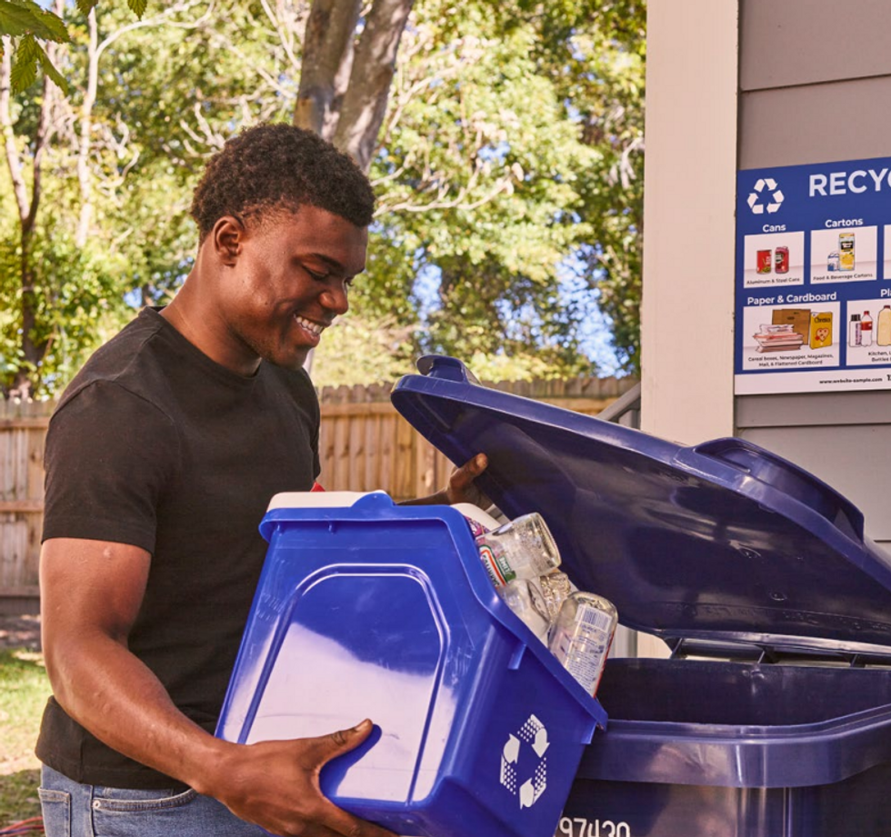 Man recycling and smiling