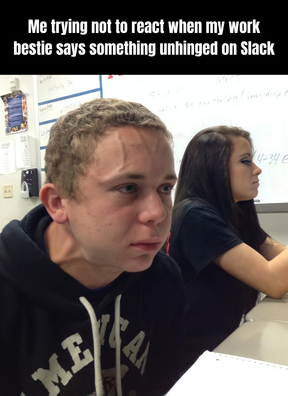 Meme showing two students in a classroom. One is casually working while the other is holding back something, with veins popping out of their forehead. The text says: Me trying not to react when my work bestie says something unhinged on Slack