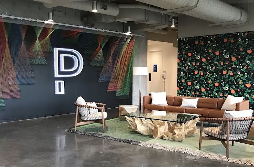 PagerDuty's Atlanta office with a sofa, coffee table, and a couple of lounge chairs
