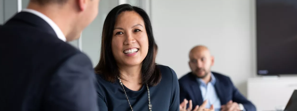Photo of a woman speaking with another colleague in an office
