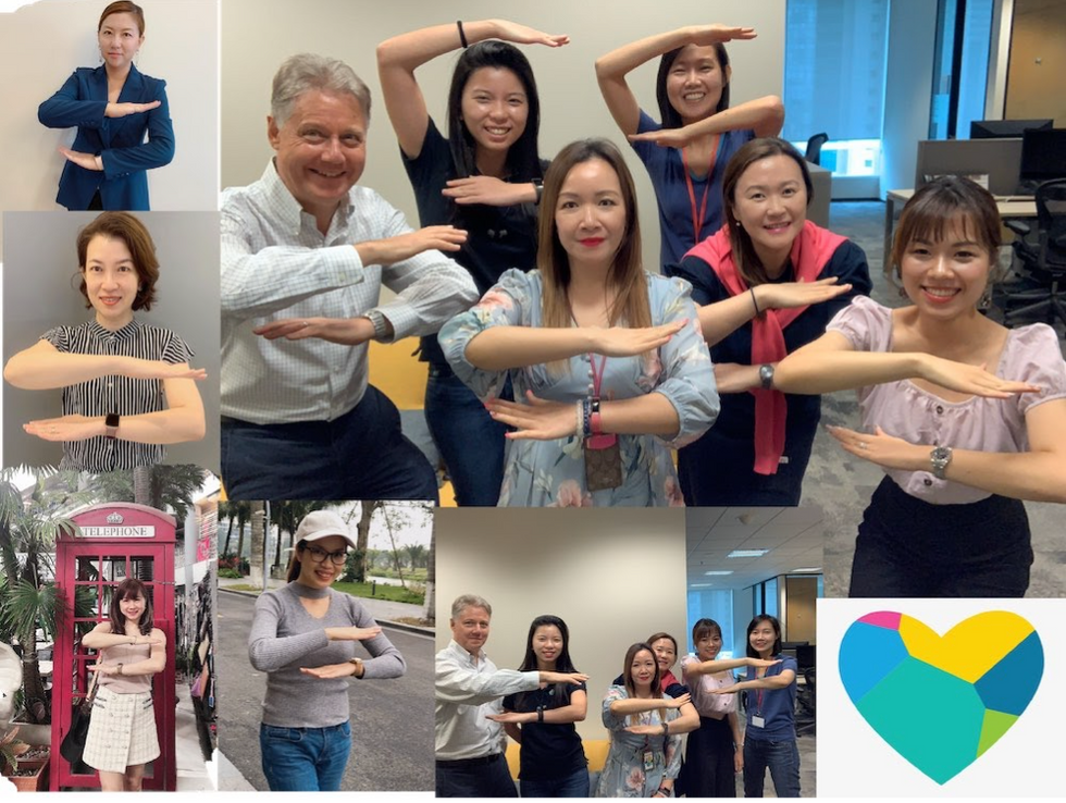 Photos of employees in Elastic\u2019s Singapore office celebrating the #EachForEqual theme of IWD last year, making the equal sign with their arms