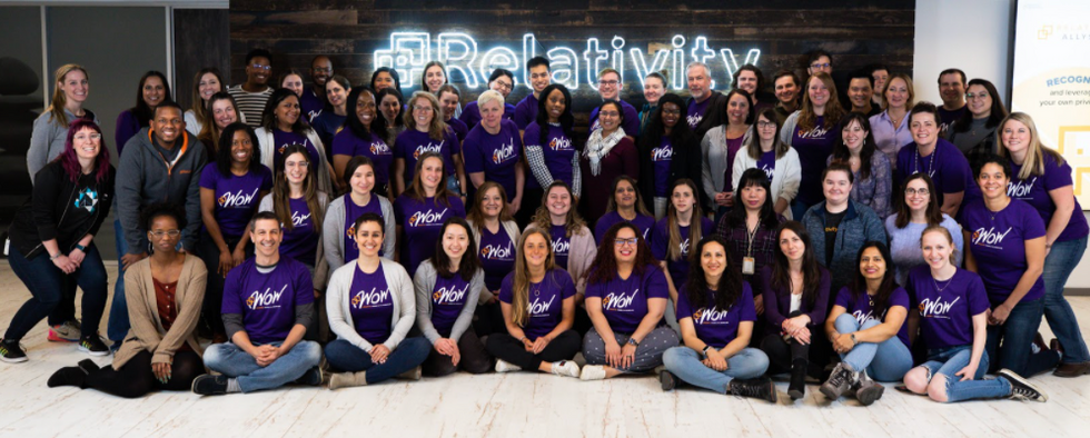 Relativity employees sitting for a group photo for International Women\u2019s Day celebrations in 2020