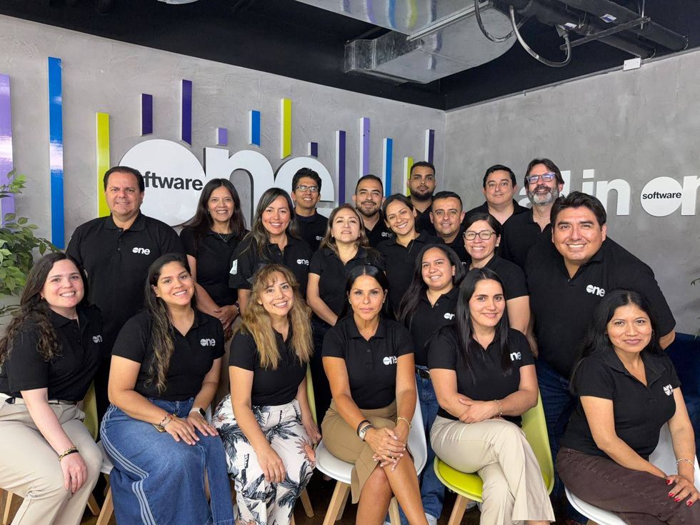 SoftwareOne team members posing together in an office, highlighting collaboration and internal career development.