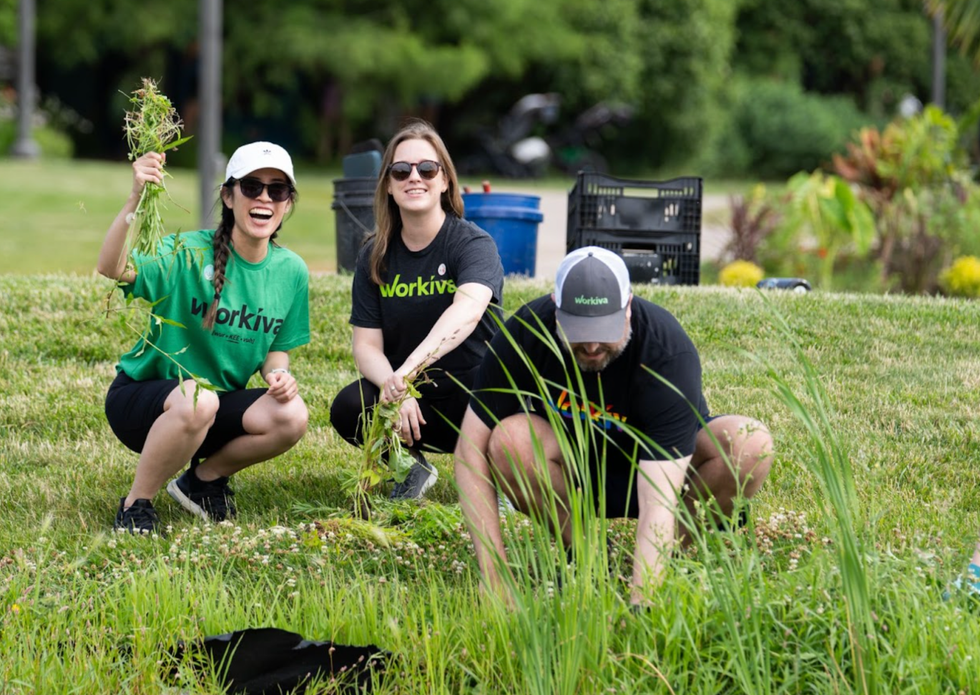 Three Workiva employees volunteering in a garden