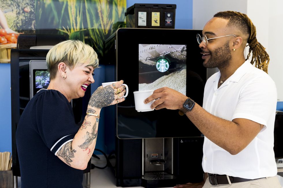 Two Nestl\u00e9 employees drinking coffee together