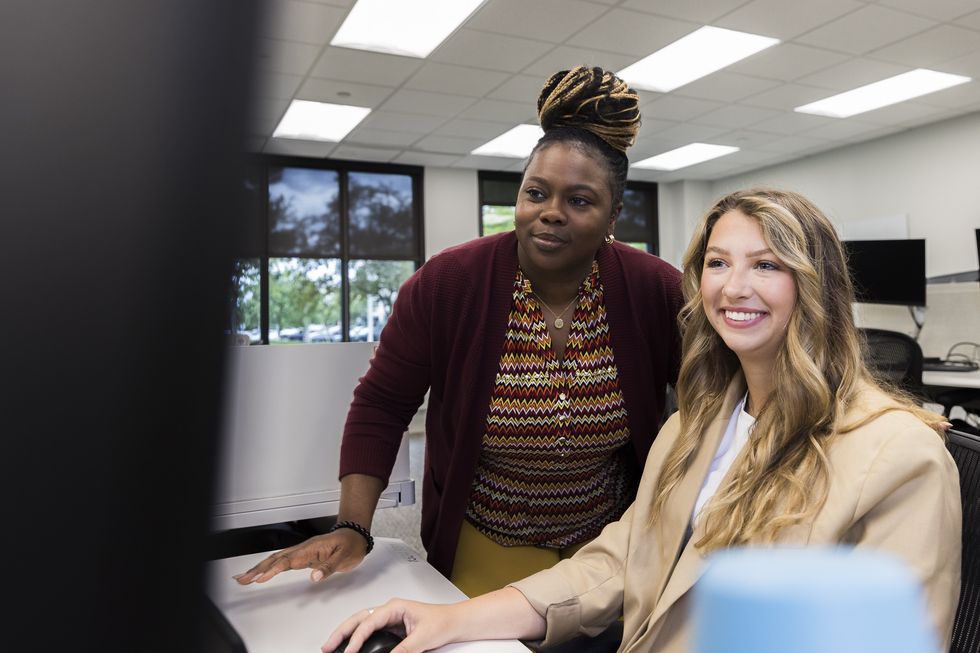 Two people looking at computer working on upskilling at Nestle