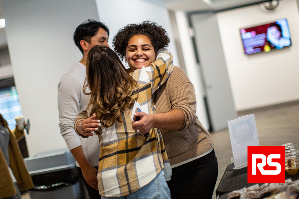 Two team members hugging