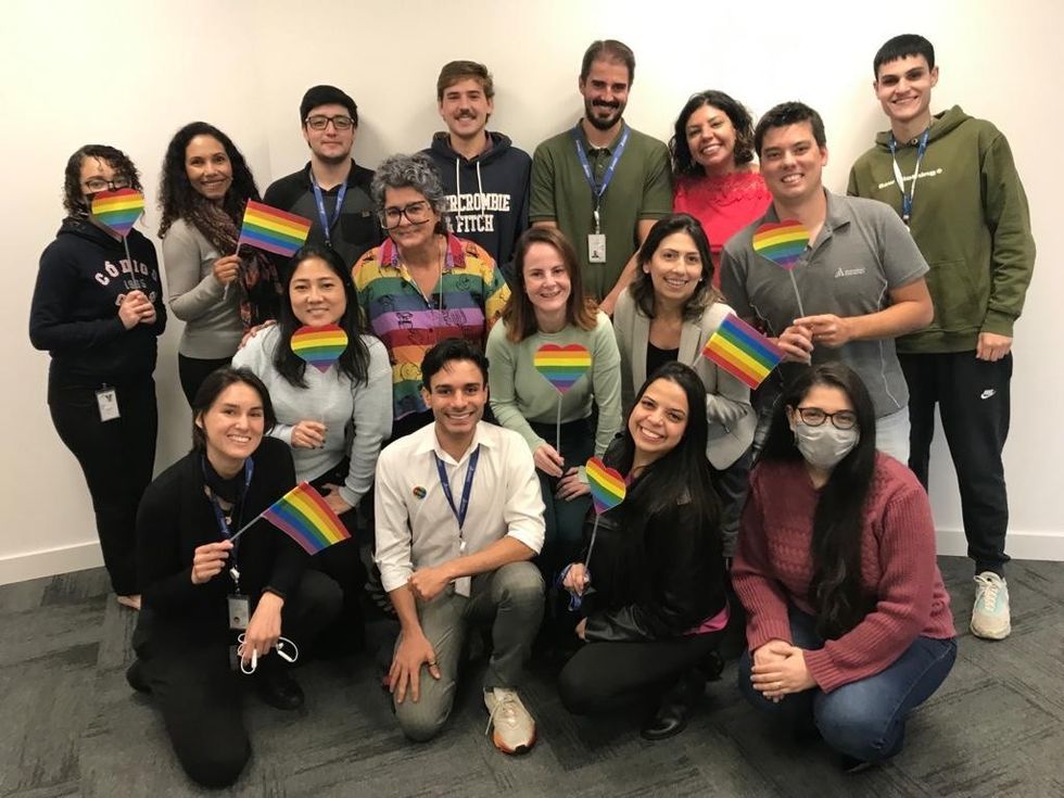 Various Dassault employees holding Pride flags