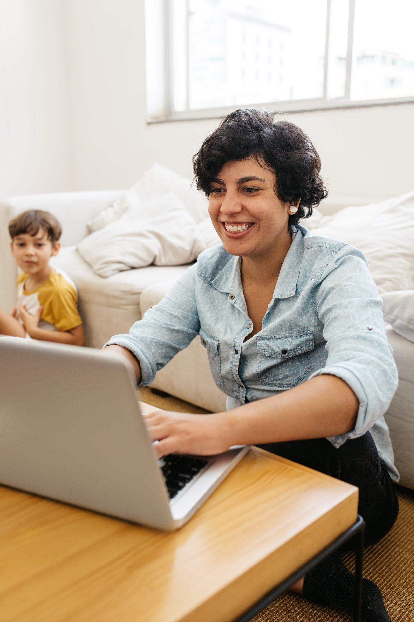 Woman smiling working remotely on a laptop