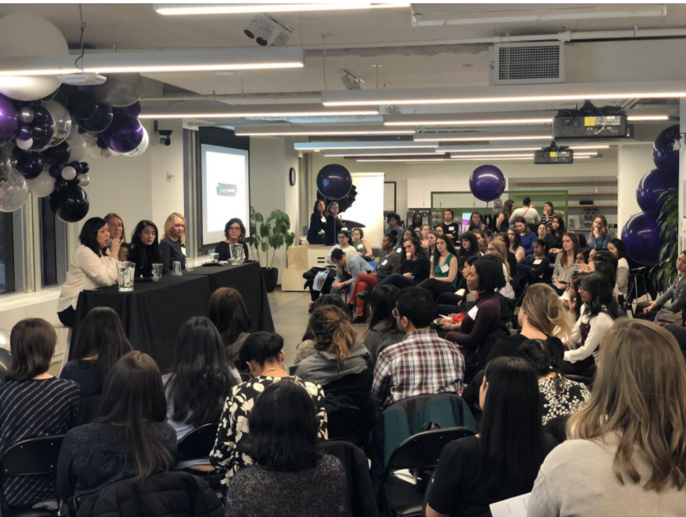 Women at MongoDB\u2019s watching a panel discussion